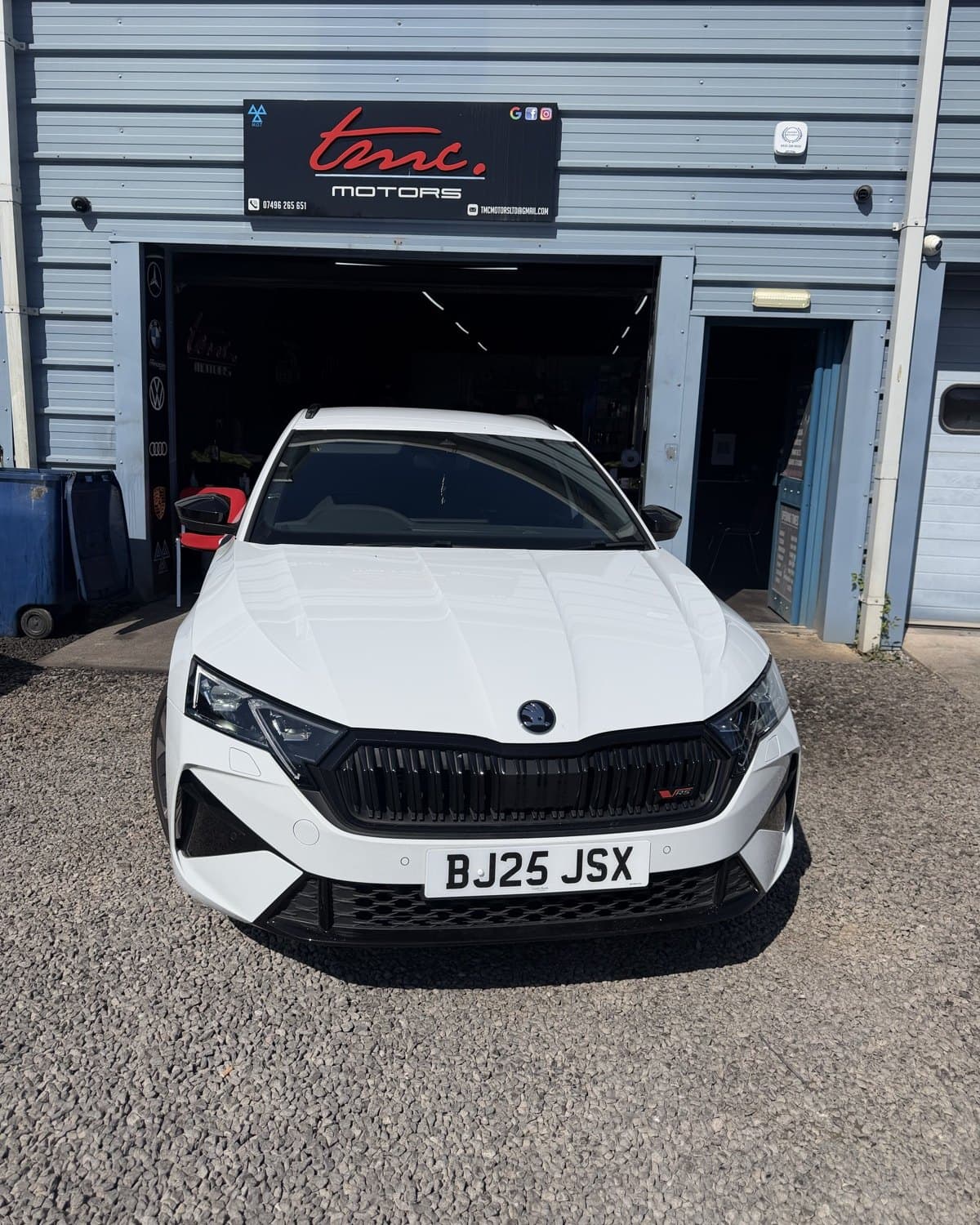 A white Skoda Octavia vRS estate outside the Team Mercedes Cardiff workshop shutter