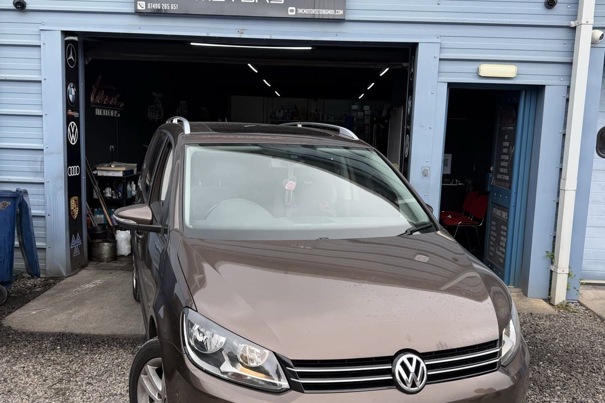A Volkswagen Touran outside the Team Mercedes Cardiff workshop