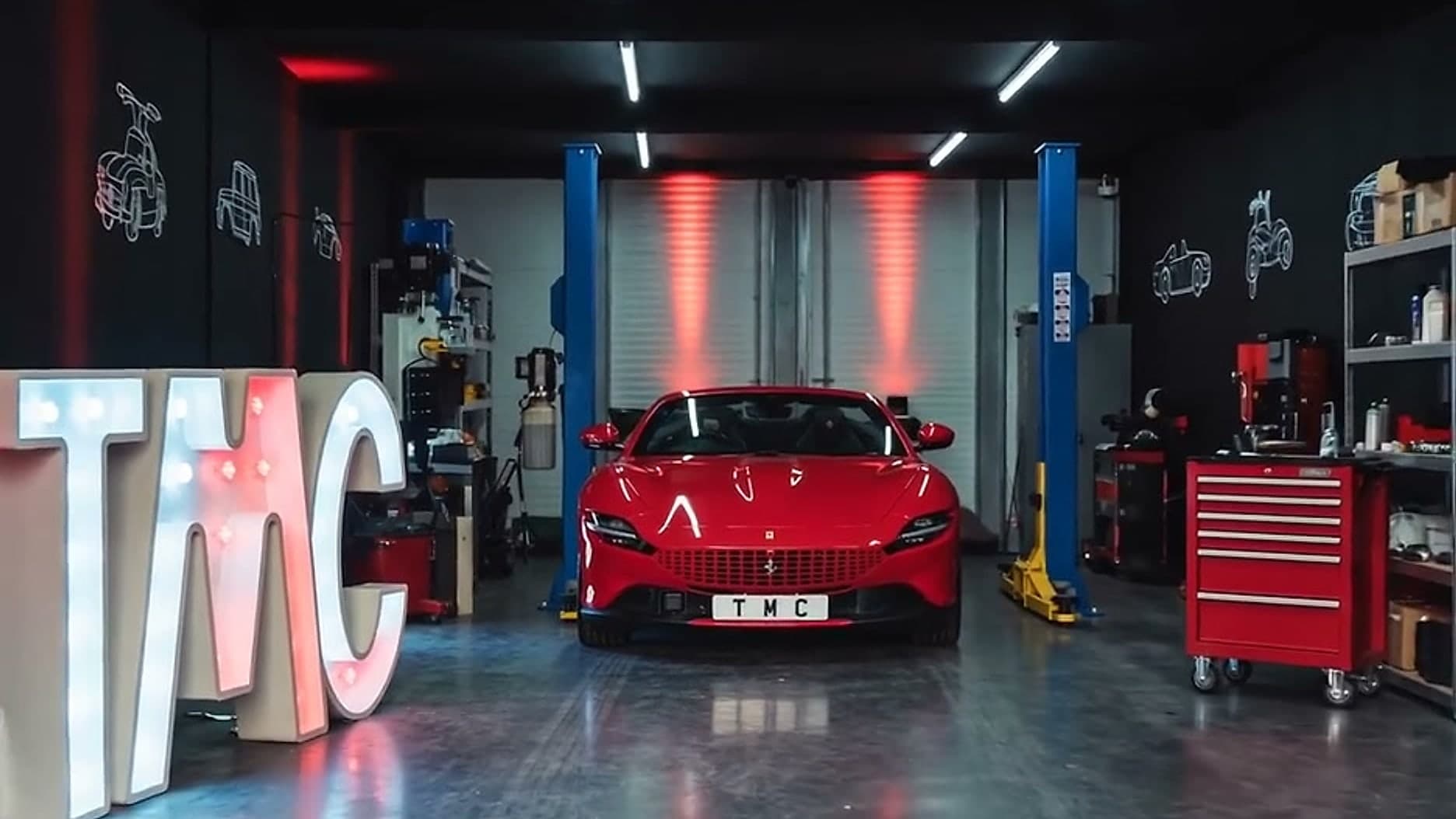 The Team Mercedes Cardiff workshop, with two-post lifts, a tool chest and the illuminated TMC letters